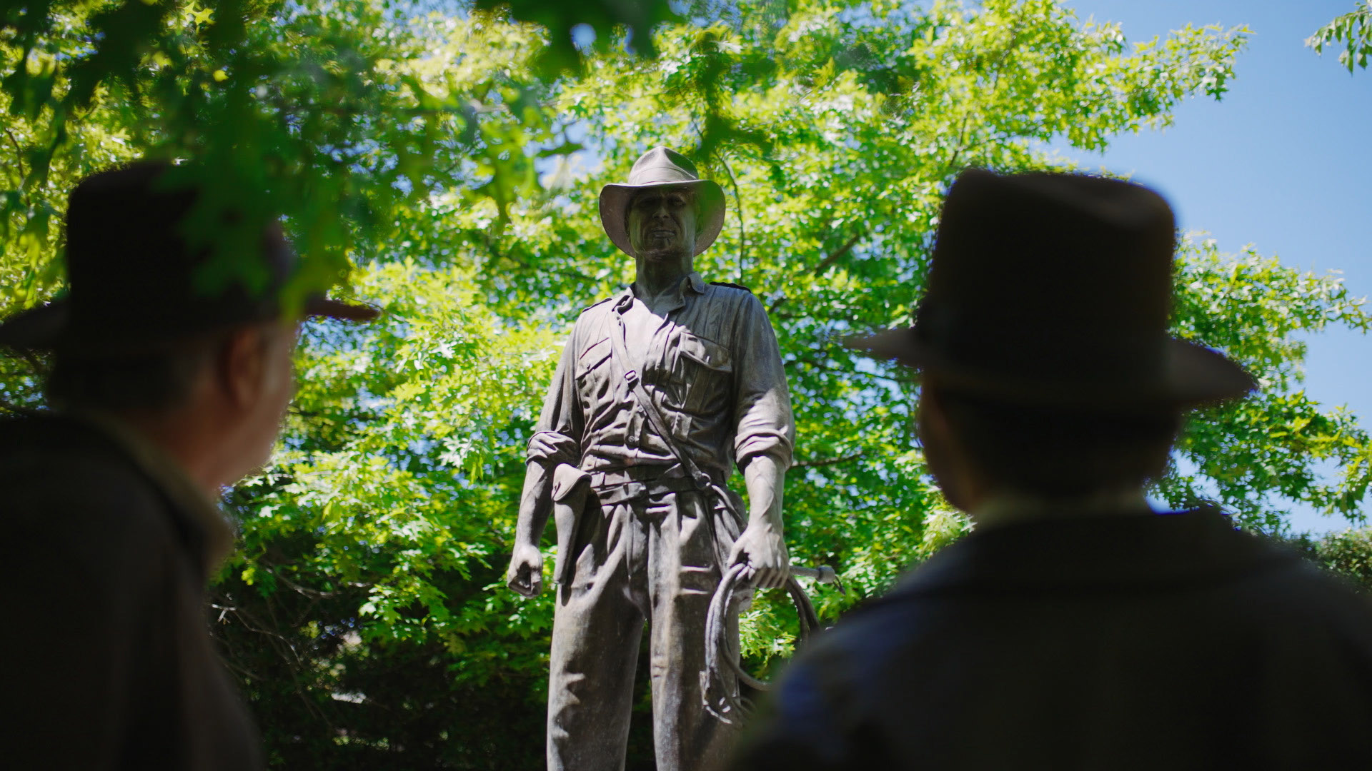 Indiana Jones fans with Indy statue.