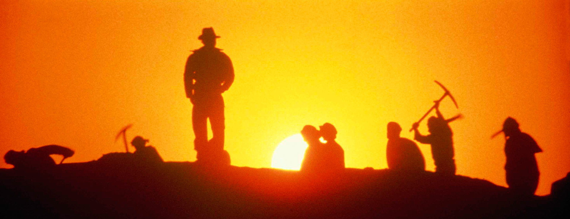 Indiana Jones and diggers at sunset.