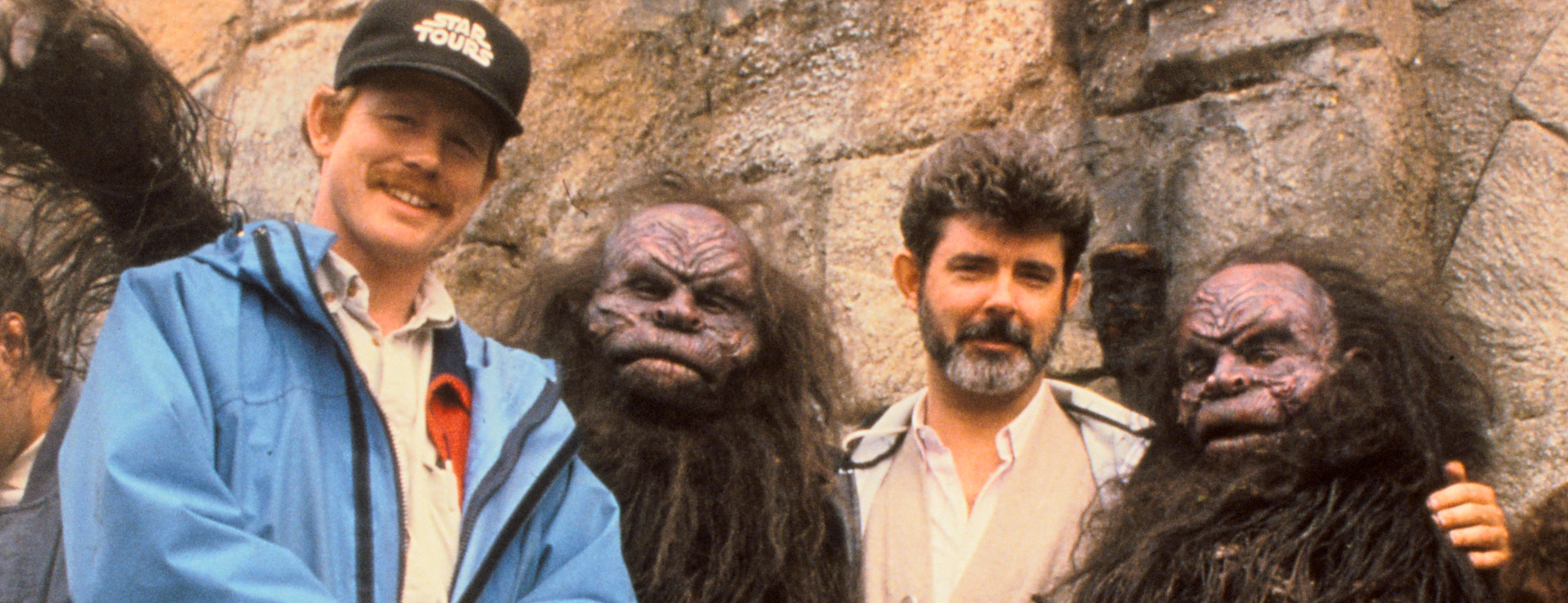 Ron Howard and George Lucas posing with trolls from the set of Willow